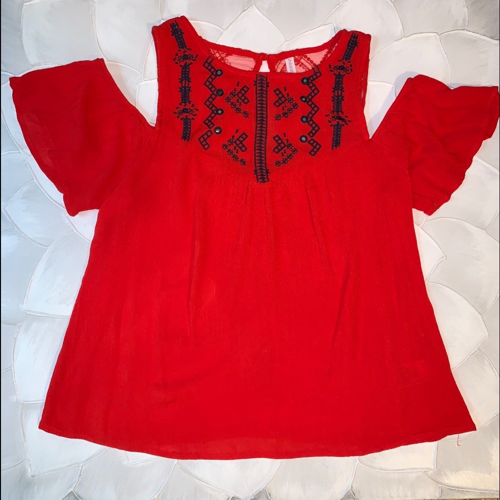 Bright red blouse with slit shoulders